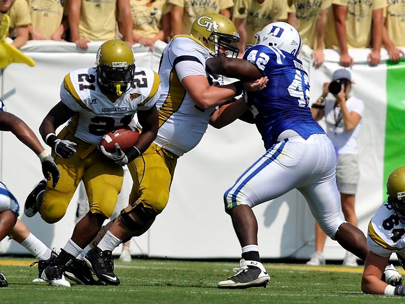 Jonathan Dwyer (21) takes advantage of good blocking by the offensive line to break through the line against Duke.