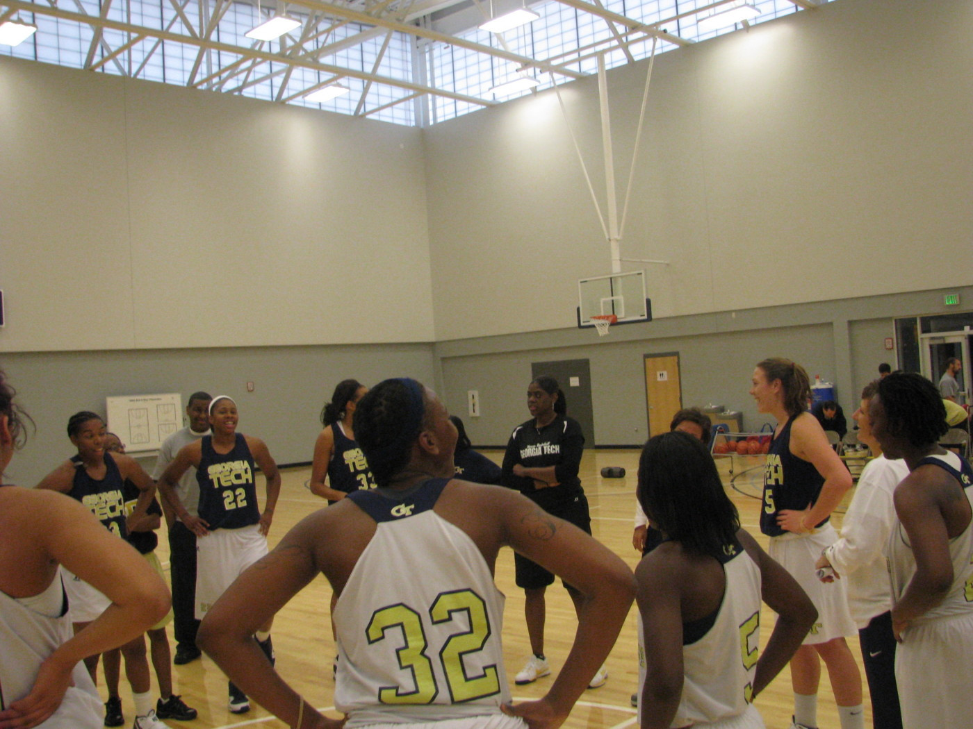 Coach Joseph addresses team before practice on the brand new Zelnak Center floor