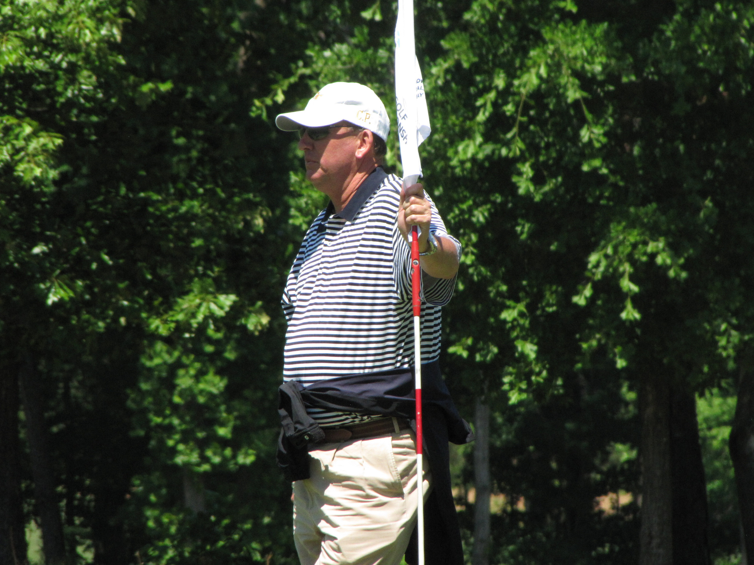 Head coach Bruce Heppler watches Ollie Schniederjans putt at the 7th green during the final round of the NCAA Raleigh Regional.