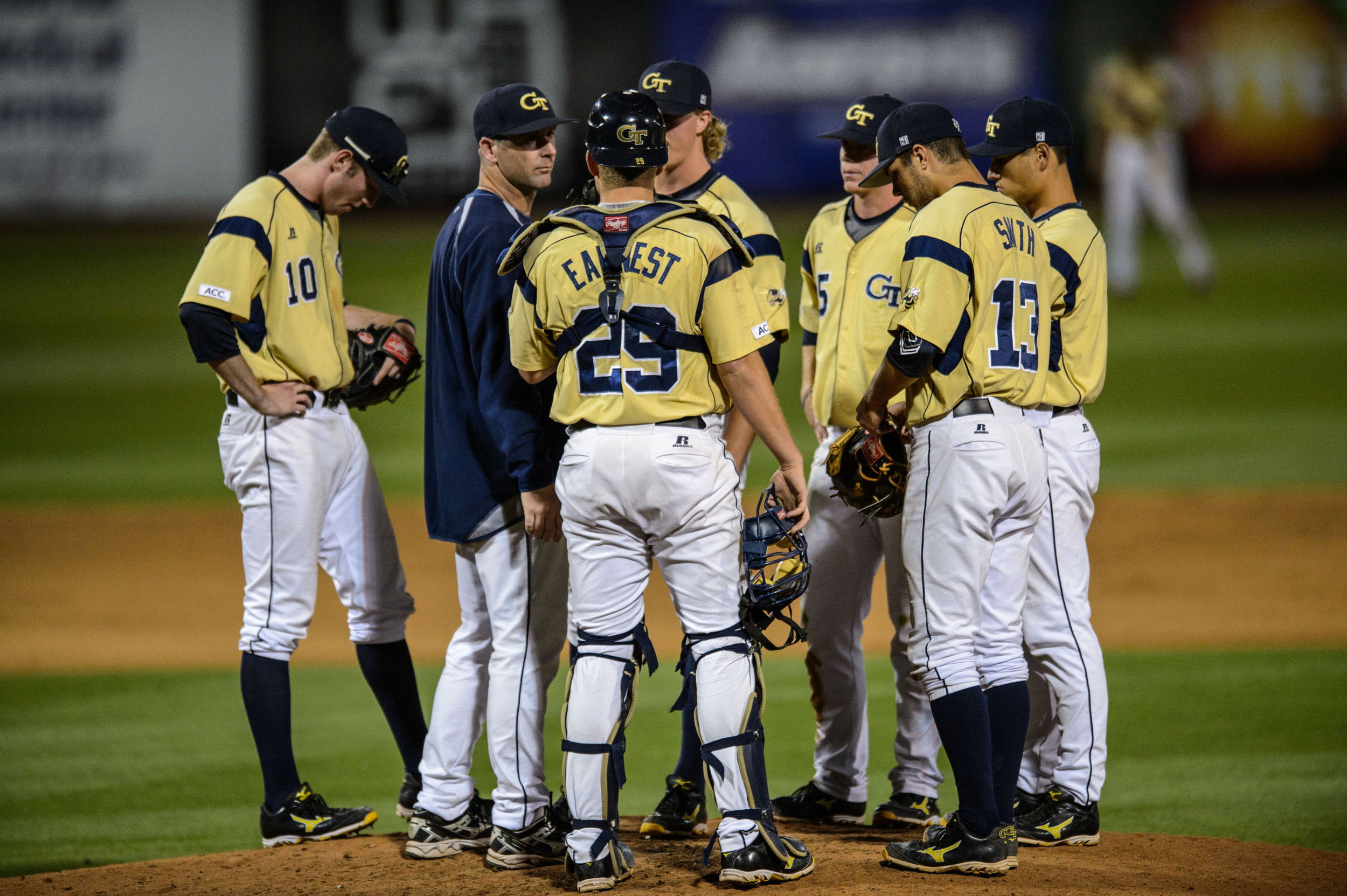 Pitching Coach Jason Howell (34) speaks to the infield.