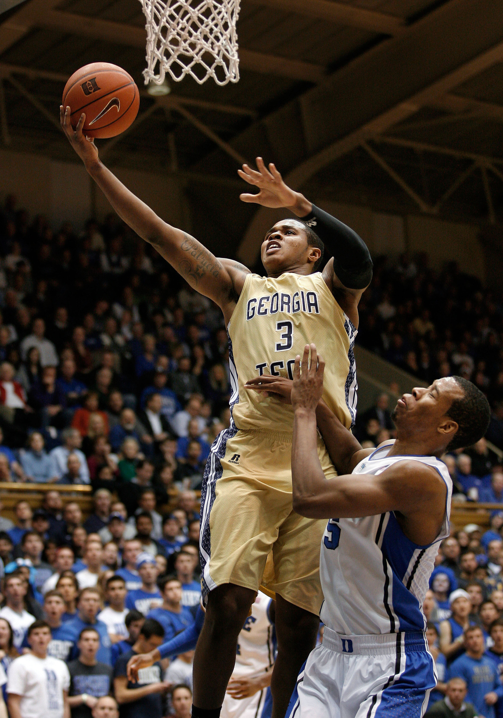 Jan 7, 2014; Durham, NC, USA; Georgia Tech Yellow Jackets guard/forward Marcus Georges-Hunt (3) drives to the basket past Duke Blue Devils forward Rodney Hood (5) at Cameron Indoor Stadium. Mandatory Credit: Mark Dolejs-USA TODAY Sports