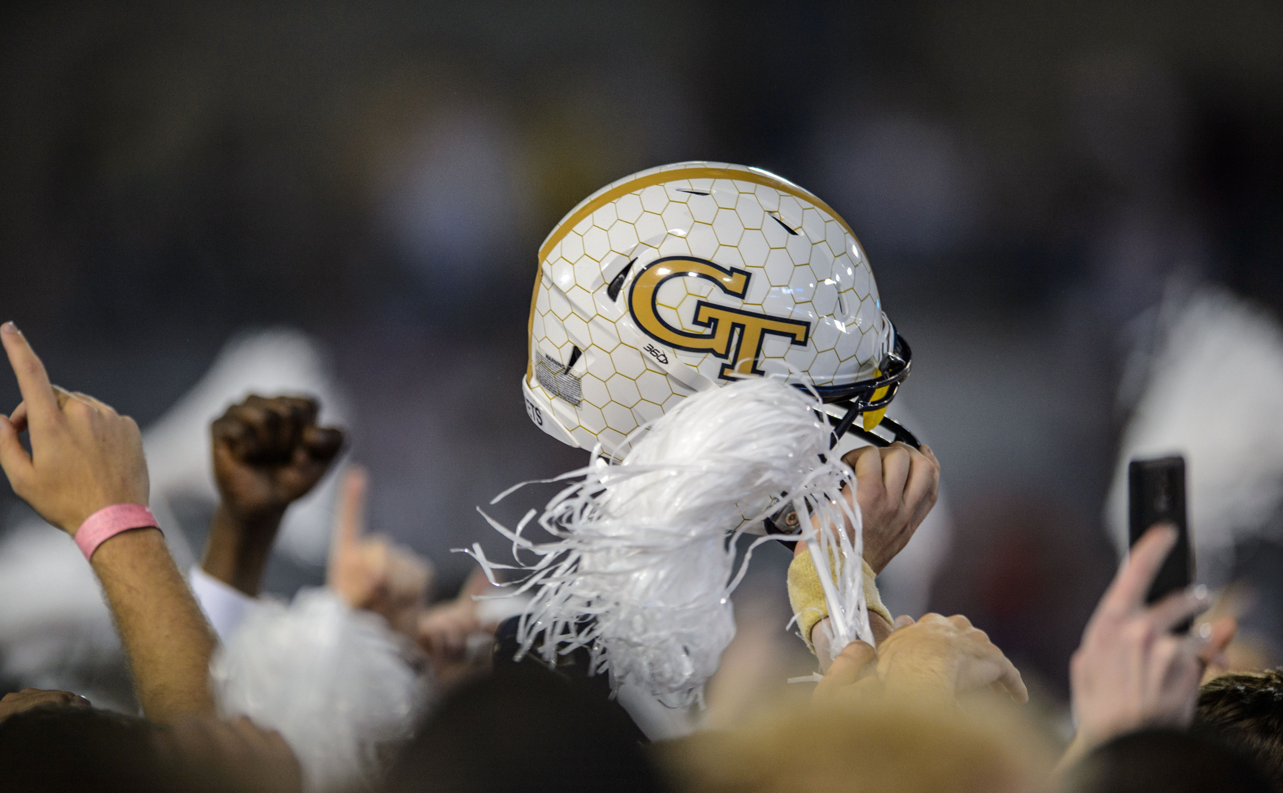 A Georgia Tech Football helmet is hoisted above the crowd after the upset victory