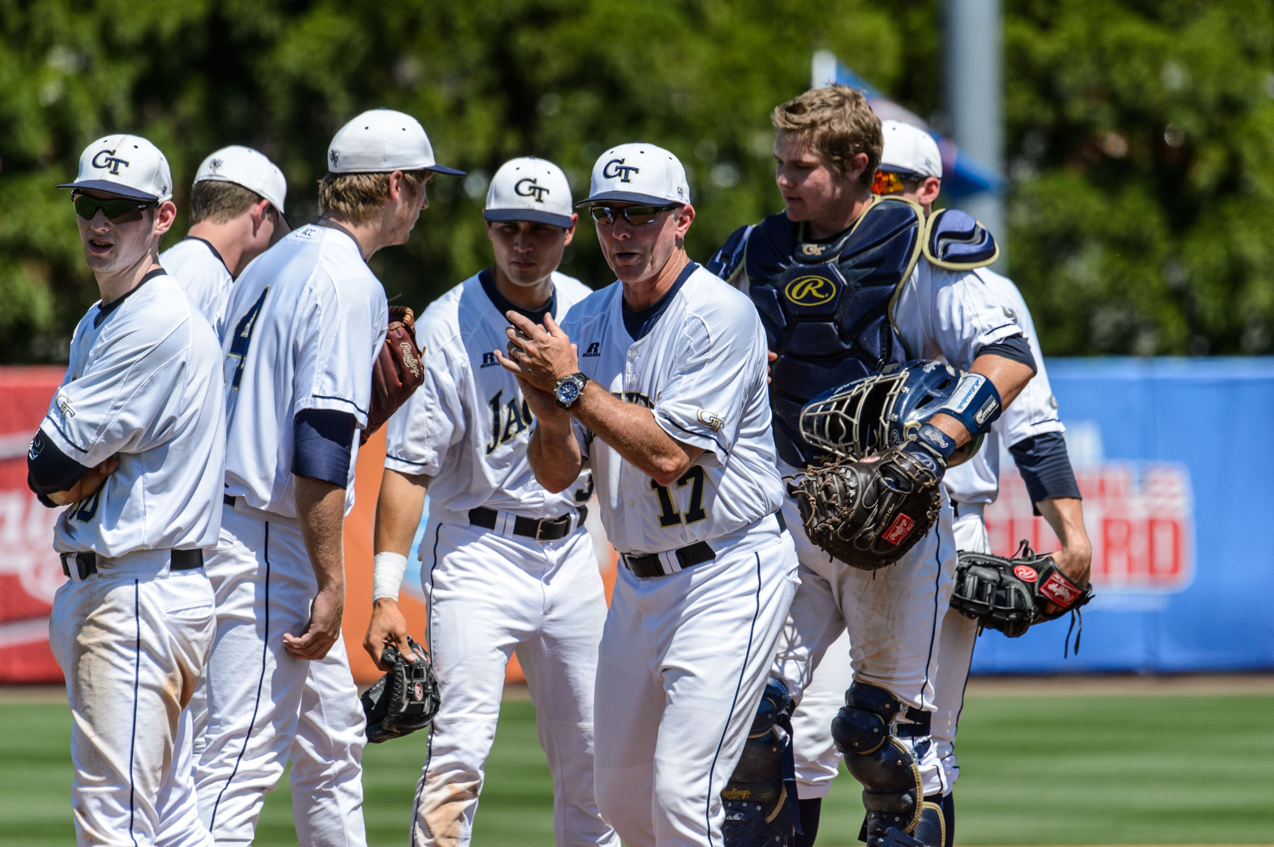 Coach Danny Hall (17) leaves the mound after a pitching change