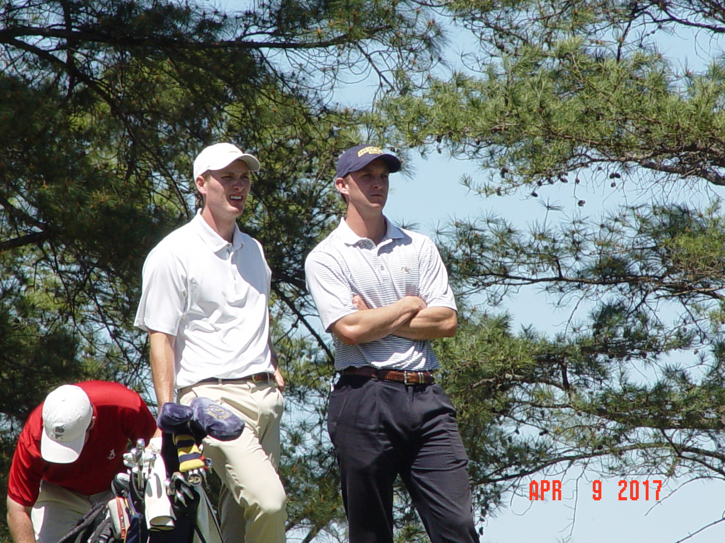 Vincent Whaley consults with assistant coach Drew McGee during the final round of the Clemson Invitational, The Cliffs at Keowee Falls, April 9, 2017