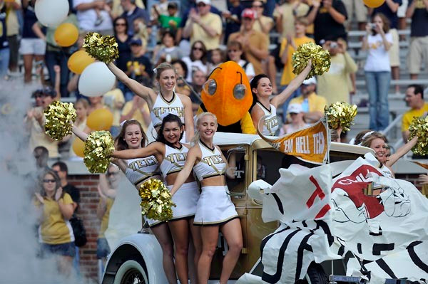 Georgia Tech cheerleaders lead the team onto the field. (Photo by LensEffects)