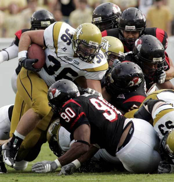 Gardner Webb defenders, including nose tackle Kyle Daye (90), stop Georgia Tech running back Lucas Cox (36) during the second half.