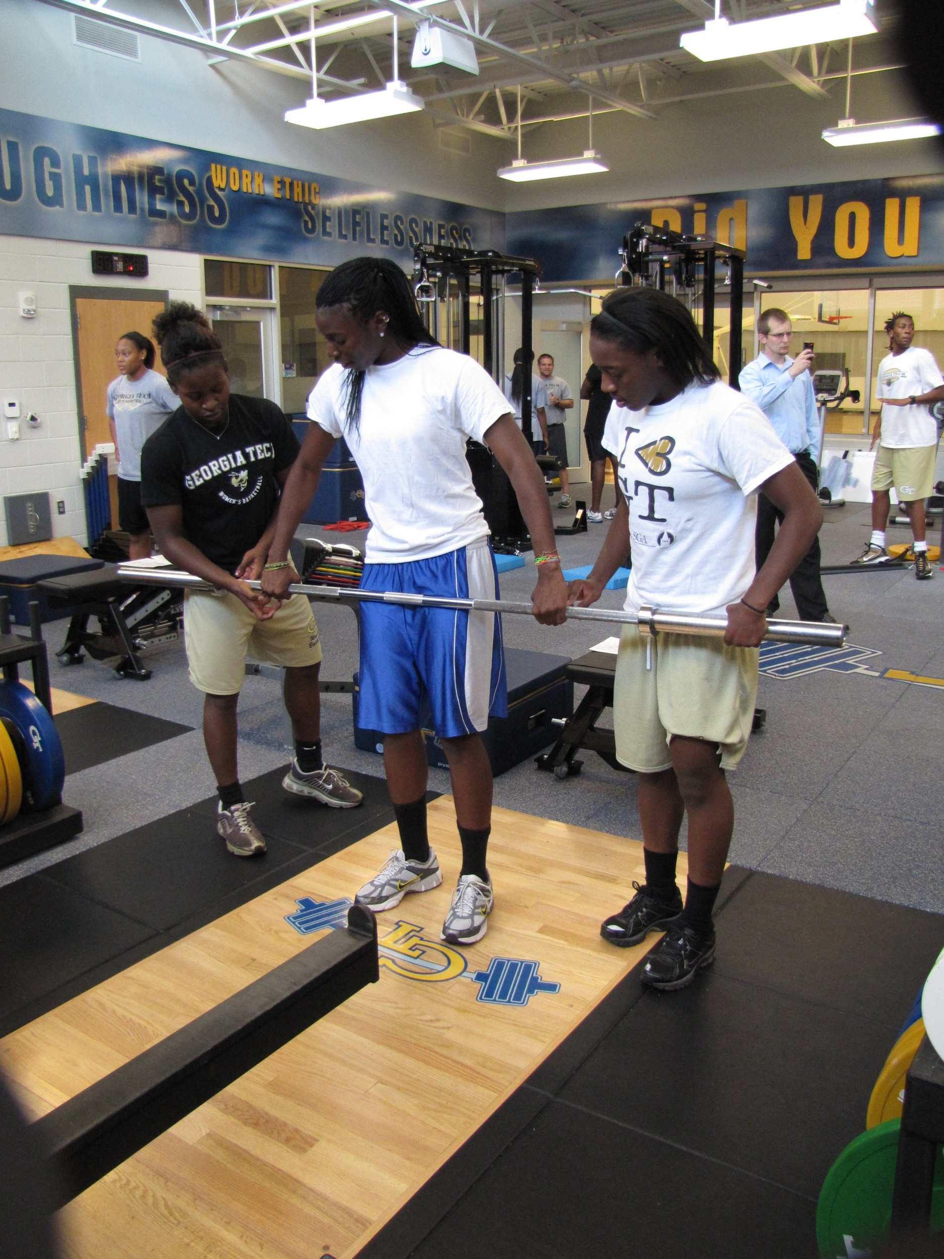 Erica Thompson and Metra Walthour help out freshman Ty Marshall