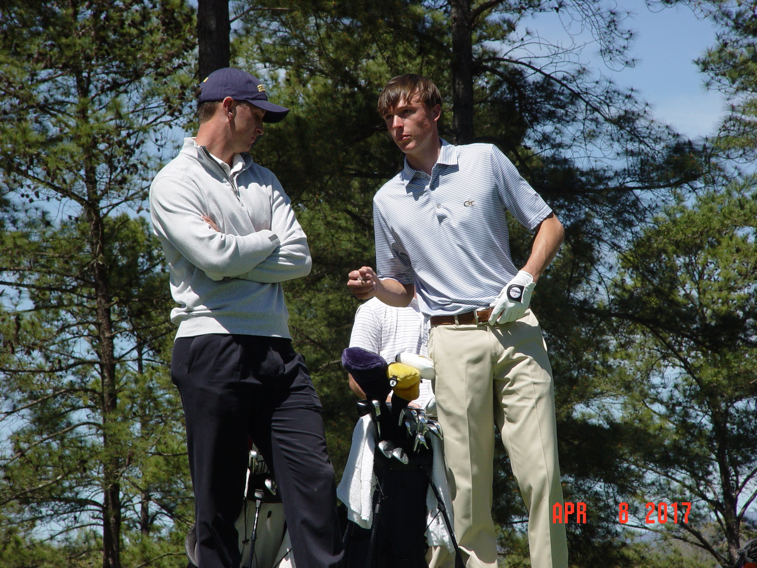 Luke Schniederjans consults with assistant coach Drew McGee during the second round of the Clemson Invitational, The Cliffs at Keowee Falls, April 8, 2017