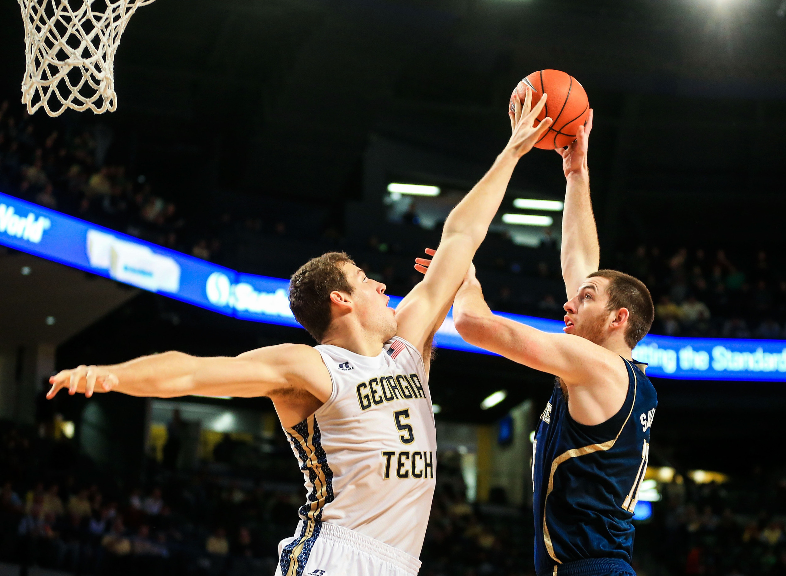 Jan 11, 2014; Atlanta, GA, USA; Georgia Tech Yellow Jackets center Daniel Miller (5) blocks a shot by Notre Dame Fighting Irish center Garrick Sherman (11) in the first half at Hank McCamish Pavilion. Mandatory Credit: Daniel Shirey-USA TODAY Sports