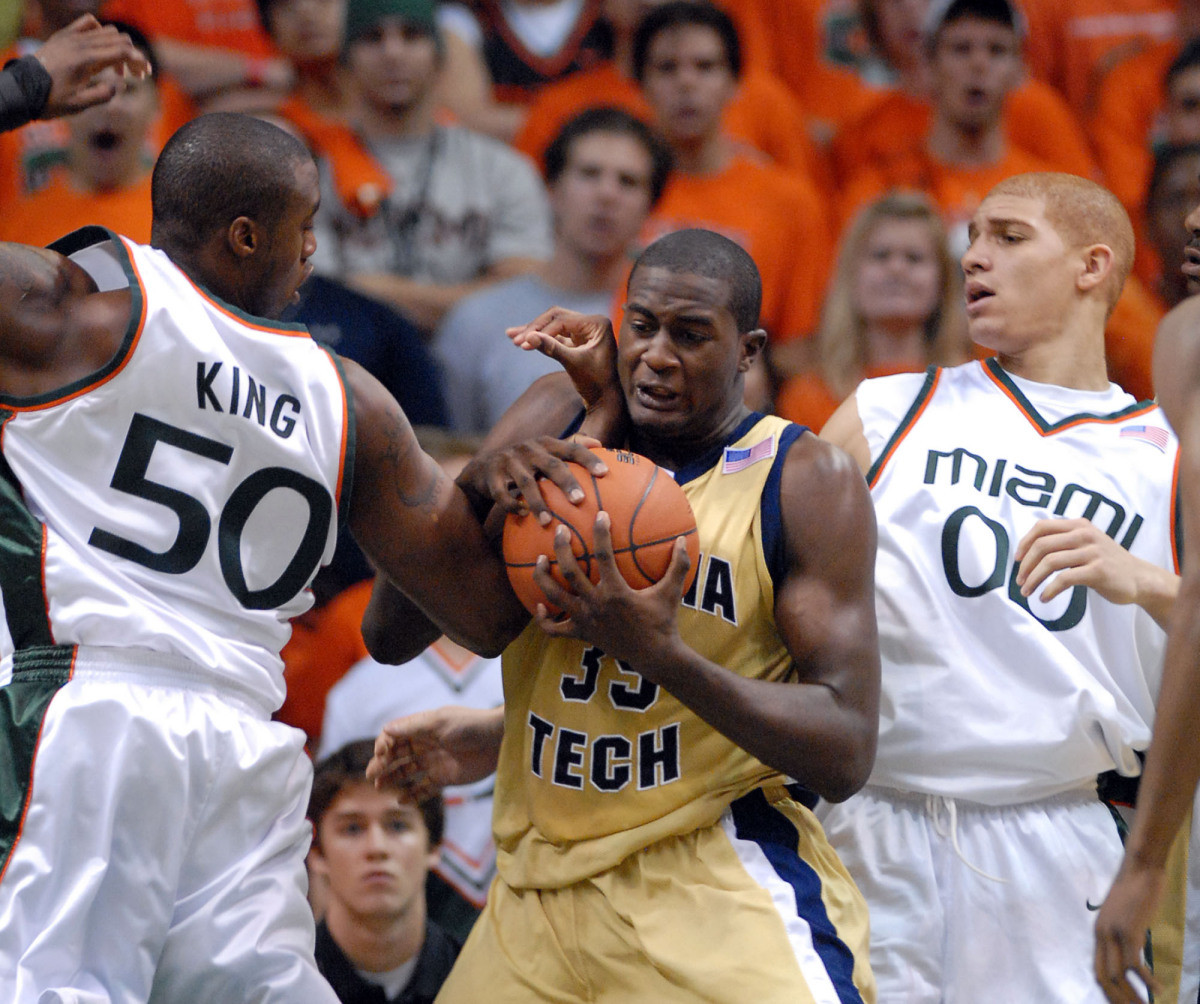 Georgia Tech forward Zach Peacock, center, fights to retain control of the ball against Miami forward Anthony King, left, and forward Jimmy Graham, during the first half of their basketball game, Sunday, Dec. 3, 2006, at the BankUnited Center on the campus of UM in Coral Gables, Fla. (AP Photo/David Adame)