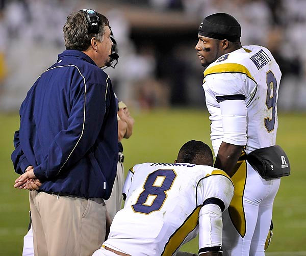 Josh Nesbitt (9) and Head Coach Paul Johnson talk during an official time out. (Photo by LensEffects)
