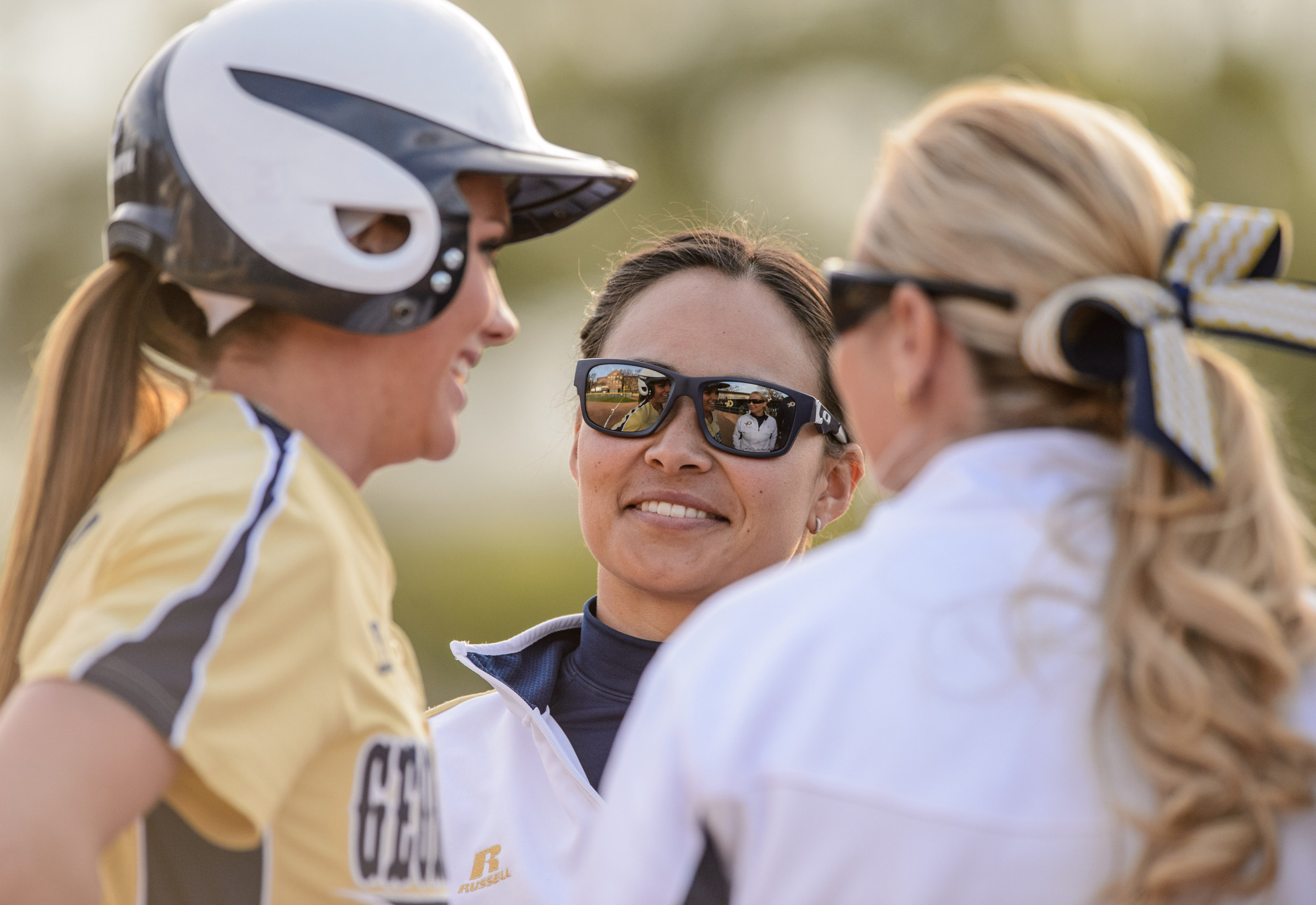 Volunteer Assistant Coach Alyssa Ishibashi talks with Ashley Thomas (5) and Coach Shelly Hoerner