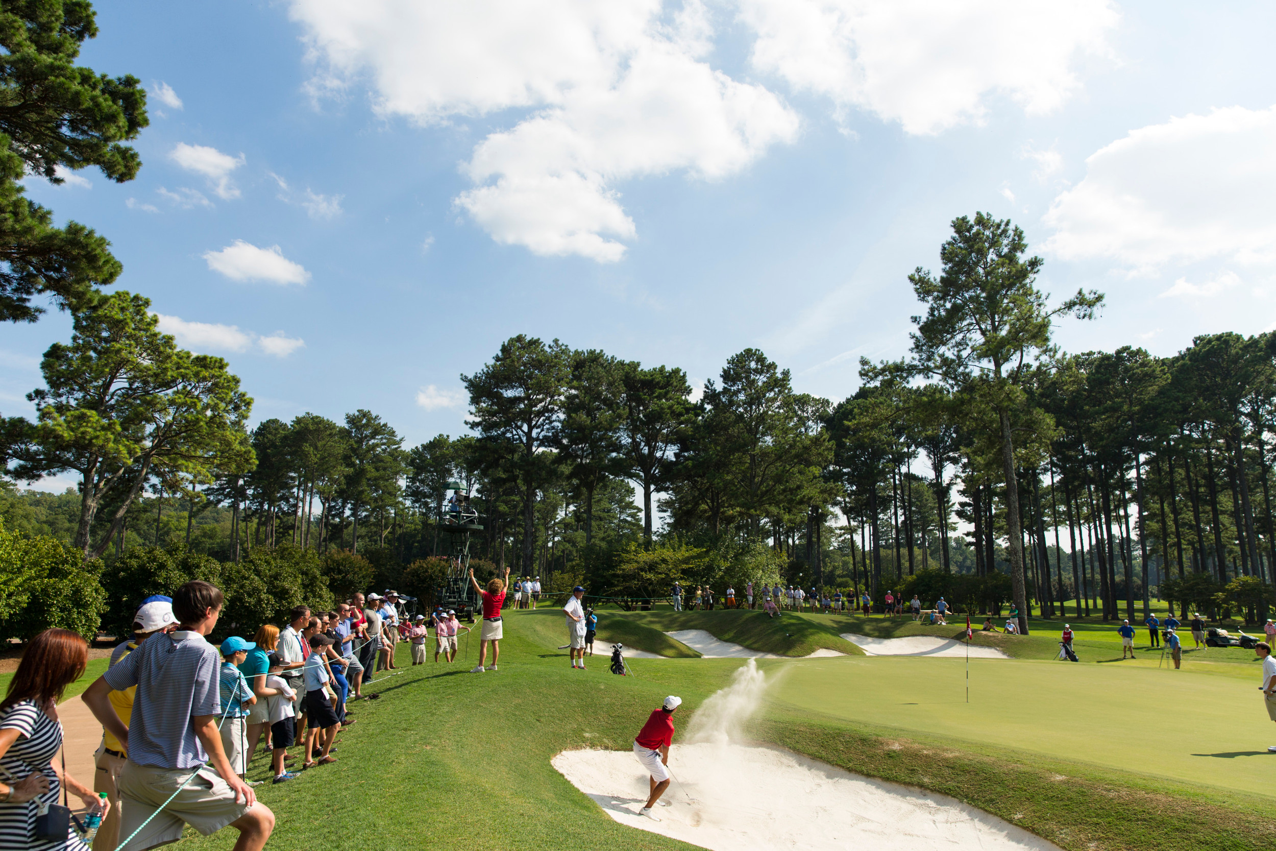 Ollie Schniederjans blasts out of a bunker on the 15th hole during the third round of match play at the 2014 U.S. Amateur at Atlanta Athletic Club in Johns Creek, Ga. on Thursday, Aug. 14, 2014. (Copyright USGA/John Mummert)