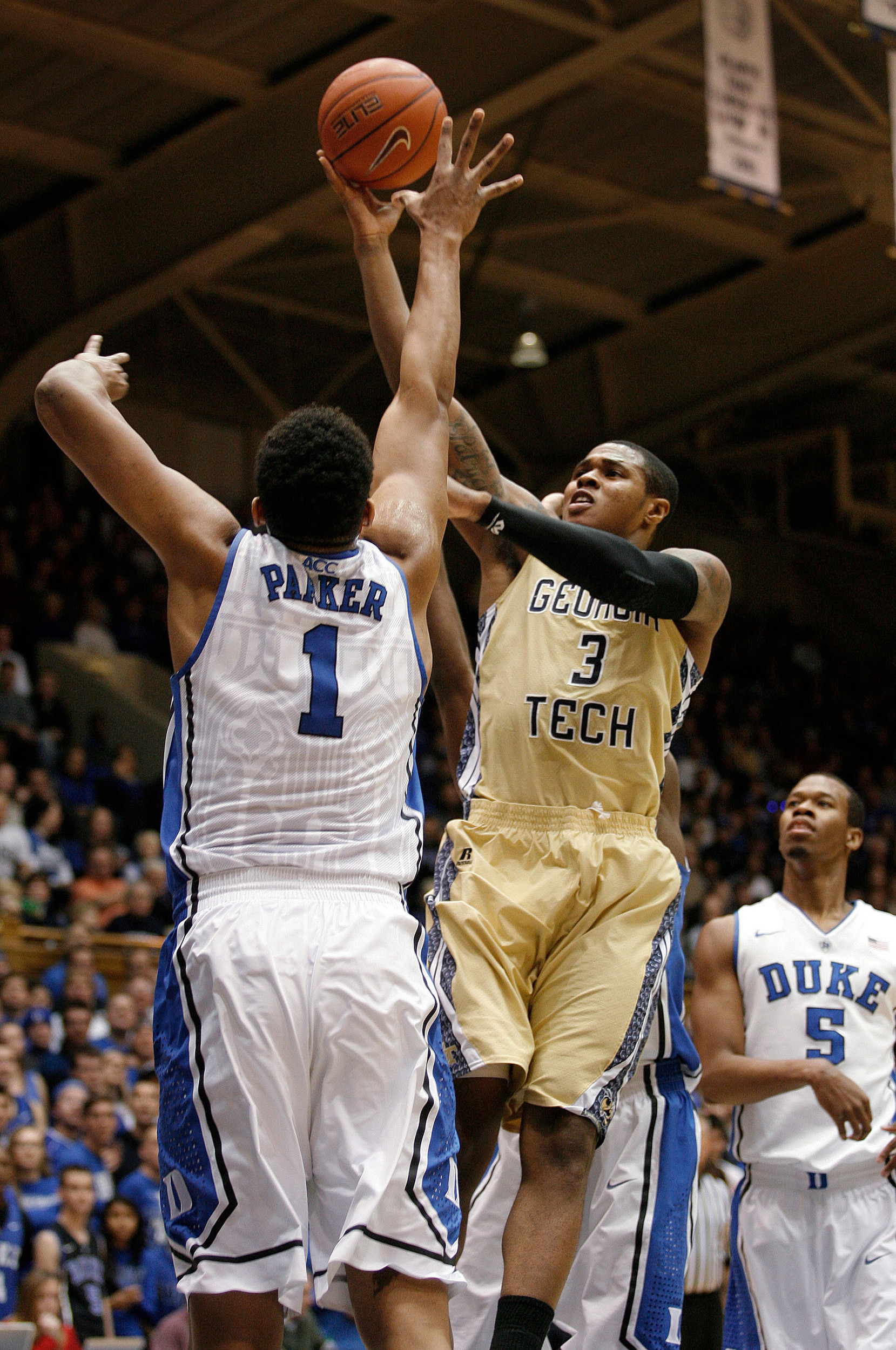 Jan 7, 2014; Durham, NC, USA; Georgia Tech Yellow Jackets guard/forward Marcus Georges-Hunt (3) shoots over Duke Blue Devils forward Jabari Parker (1) at Cameron Indoor Stadium. Mandatory Credit: Mark Dolejs-USA TODAY Sports