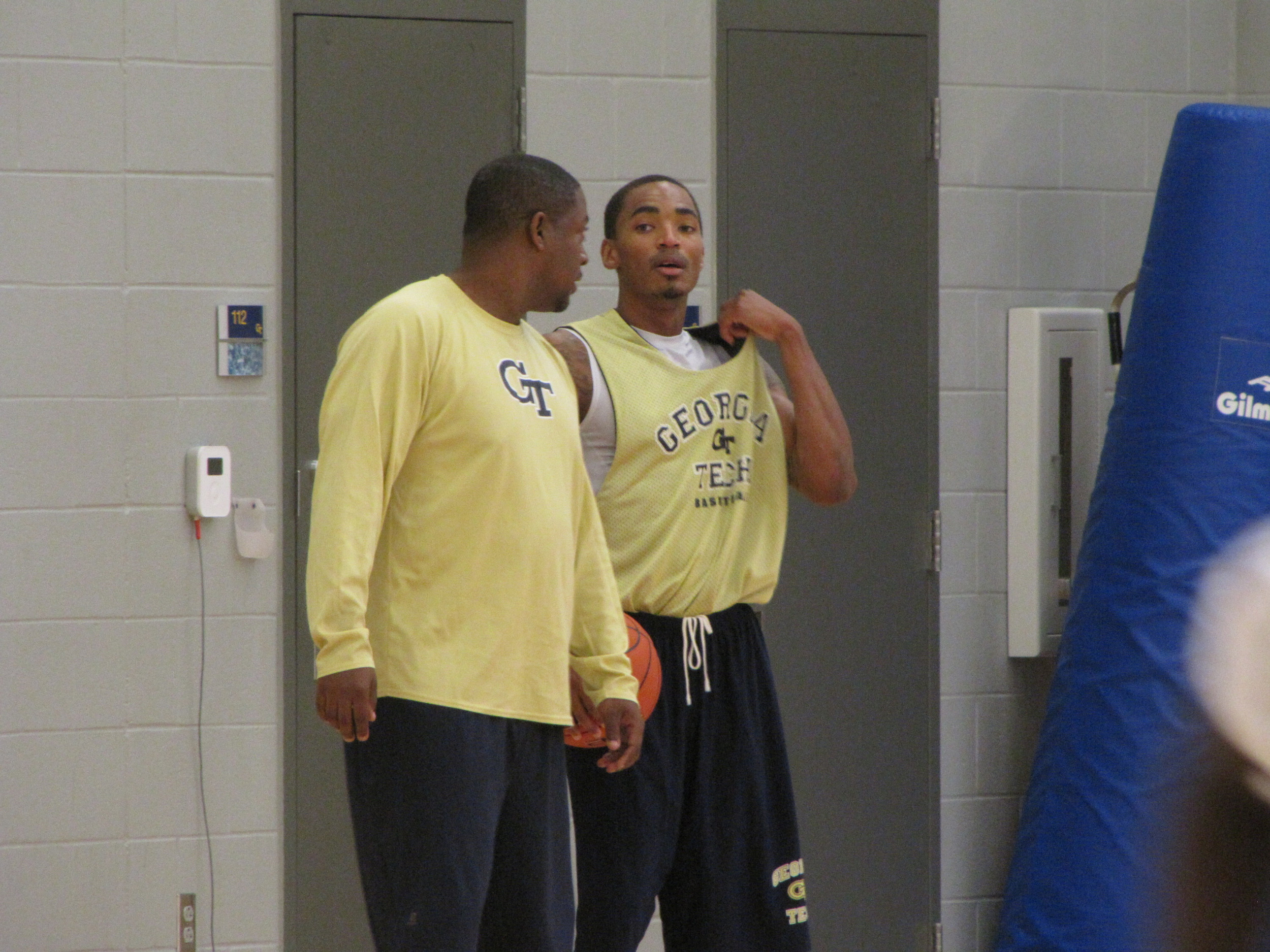 Assistant coach Chad Dollar chats with Pierre Jordan.