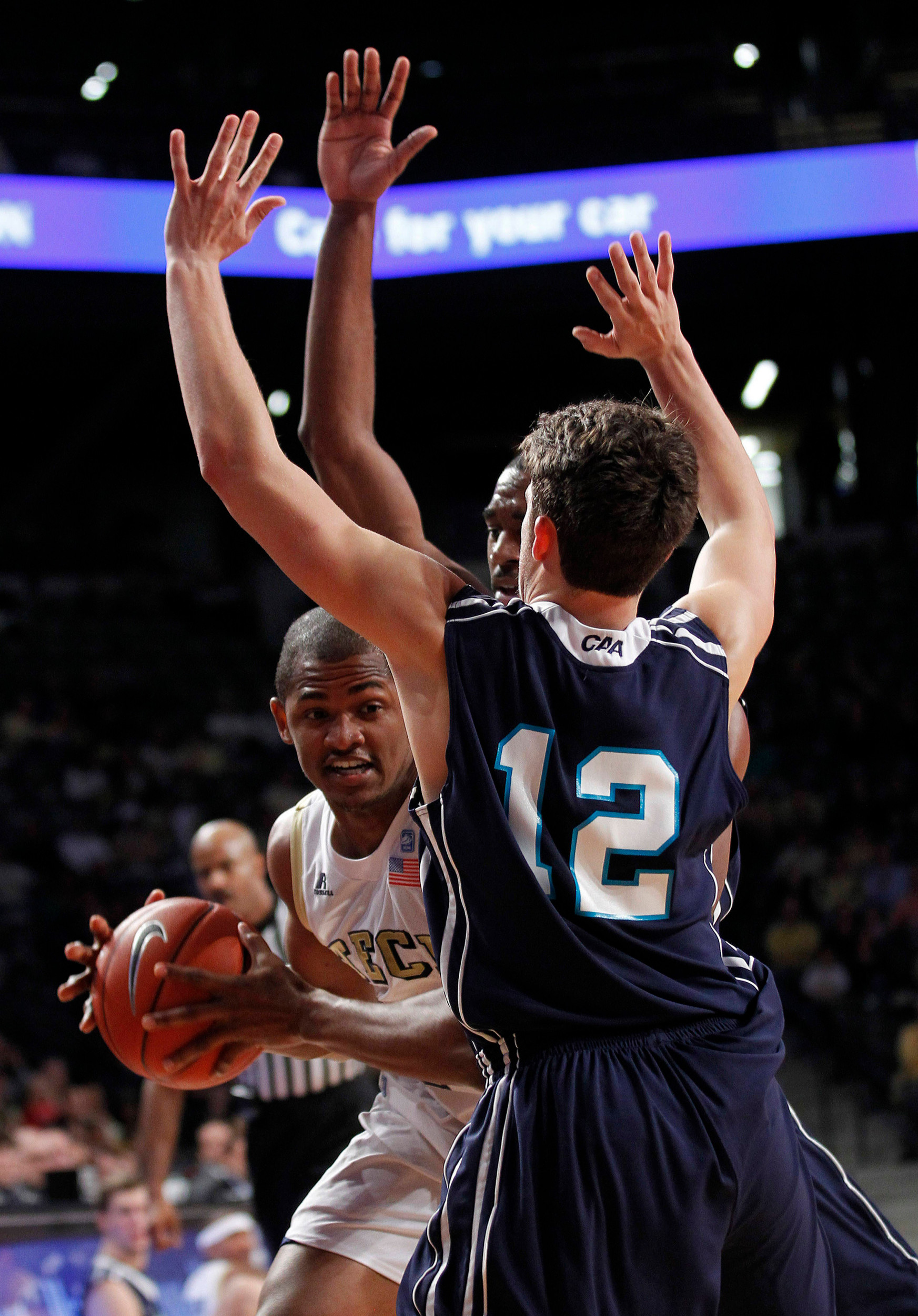 Georgia Tech's Jason Morris, left, is covered by North Carolina-Wilmington guard Tanner Milson (12) in the first half. (AP Photo/John Bazemore)
