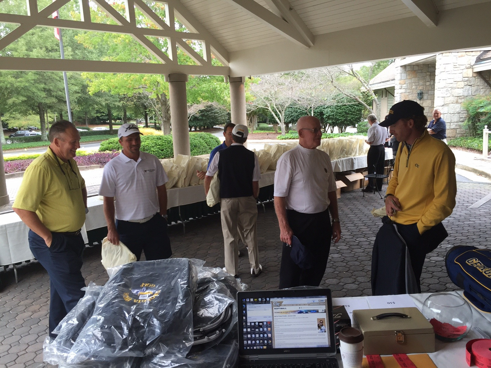 Head coach Bruce Heppler chats with Nicholas Thompson, while booster Jon Martin talks with Roberto Castro at the Ramblinwreck Cup - Golf Club of Georgia, October 5, 2015