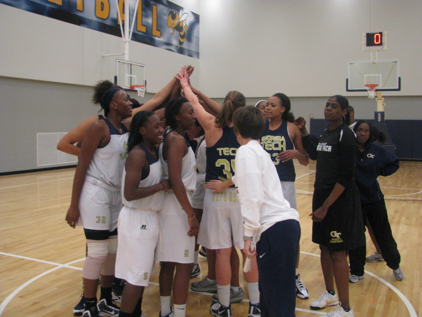 Coach Joseph addresses team before practice on the brand new Zelnak Center floor