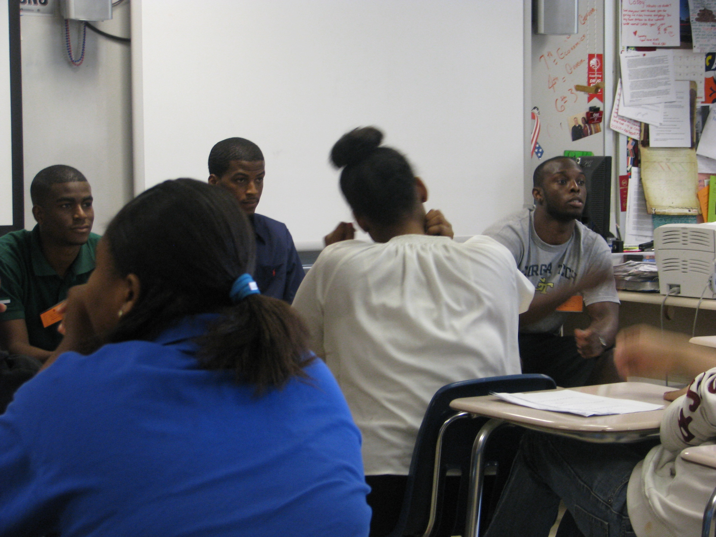 Mfon Udofia joins college students from the area speaking to Tucker Middle School pupils about college life.