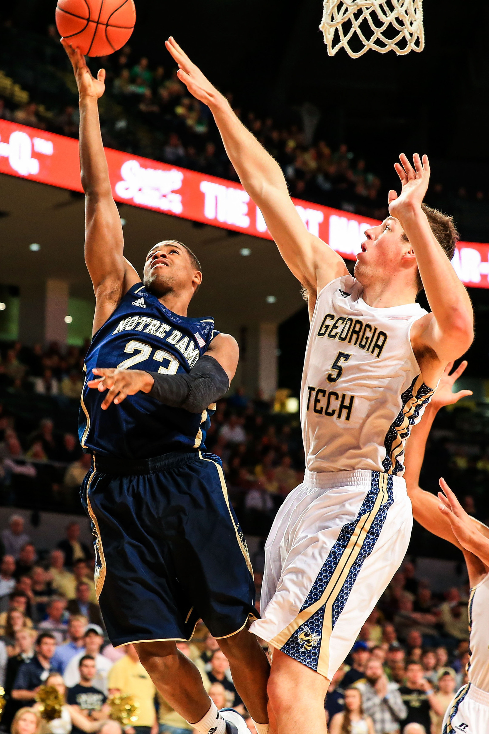 Jan 11, 2014; Atlanta, GA, USA; Notre Dame Fighting Irish guard Demetrius Jackson (23) shoots past Georgia Tech Yellow Jackets center Daniel Miller (5) in the first half at Hank McCamish Pavilion. Mandatory Credit: Daniel Shirey-USA TODAY Sports