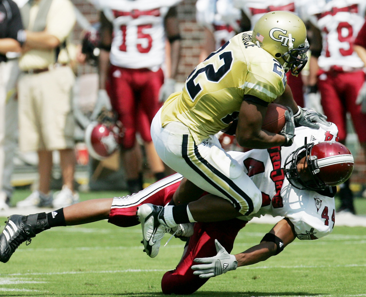 Tailback Tashard Choice holds on under pressure from Troy defensive end Randy Underwood. (AP Photo/Ric Feld)