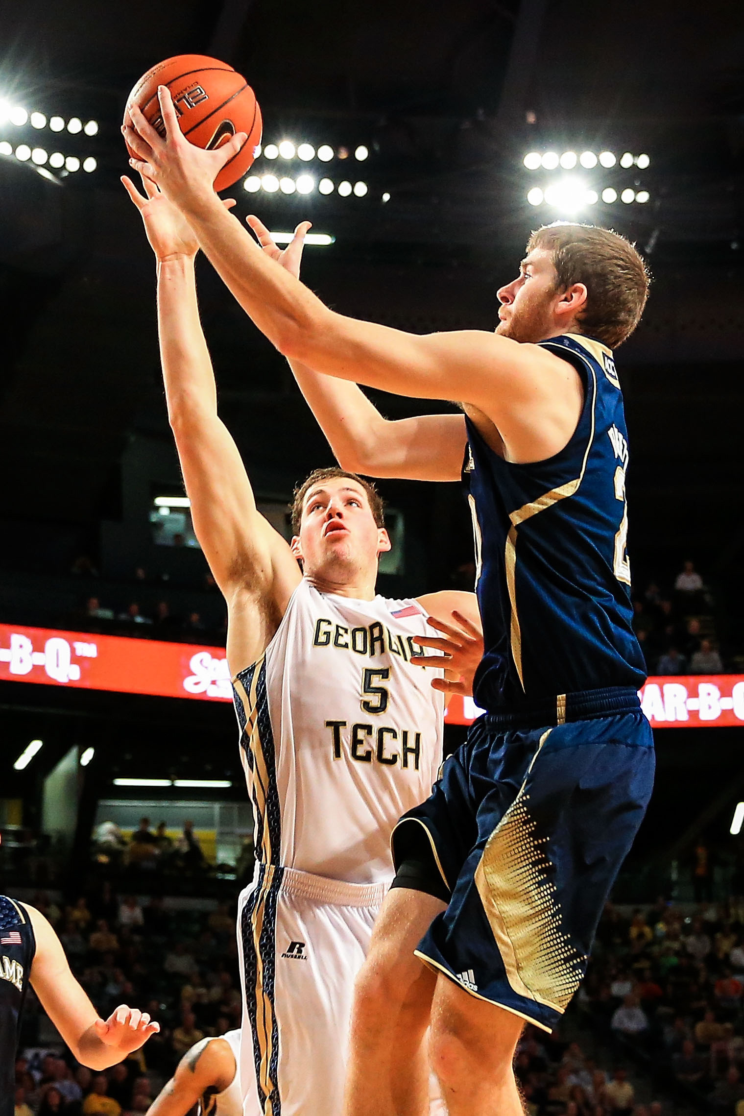 Jan 11, 2014; Atlanta, GA, USA; Notre Dame Fighting Irish forward Austin Burgett (20) shoots over Georgia Tech Yellow Jackets center Daniel Miller (5) in the first half at Hank McCamish Pavilion. Mandatory Credit: Daniel Shirey-USA TODAY Sports