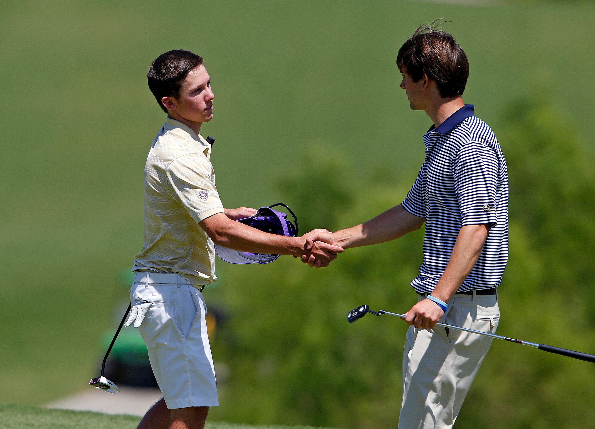 Ollie Schniederjans shakes the hand of medalist Jordan Sanders of Washington at the 18th green Saturday at the NCAA Raleigh Regional