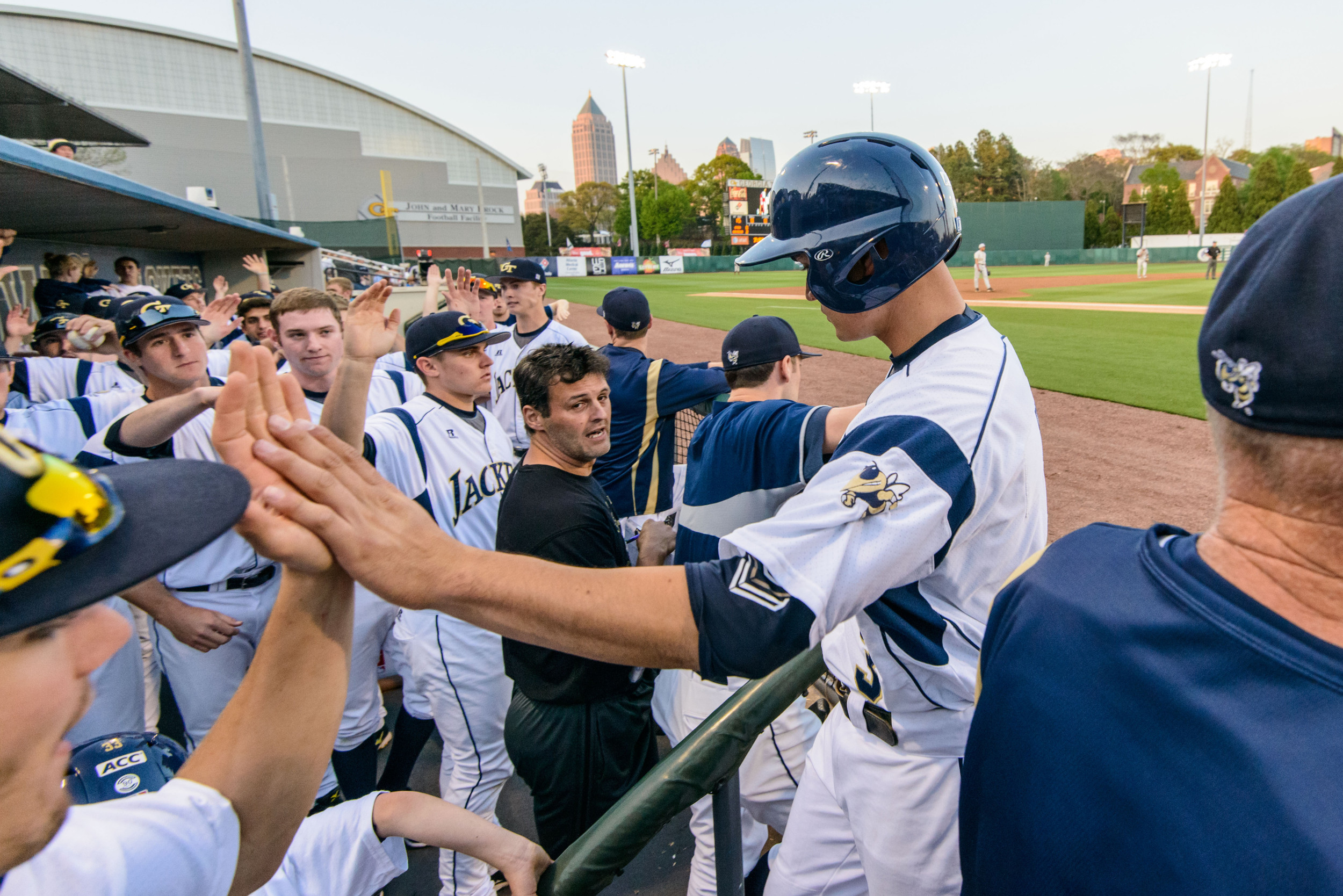 Mott Hyde (3) is welcomed back to the dugout after scoring a run