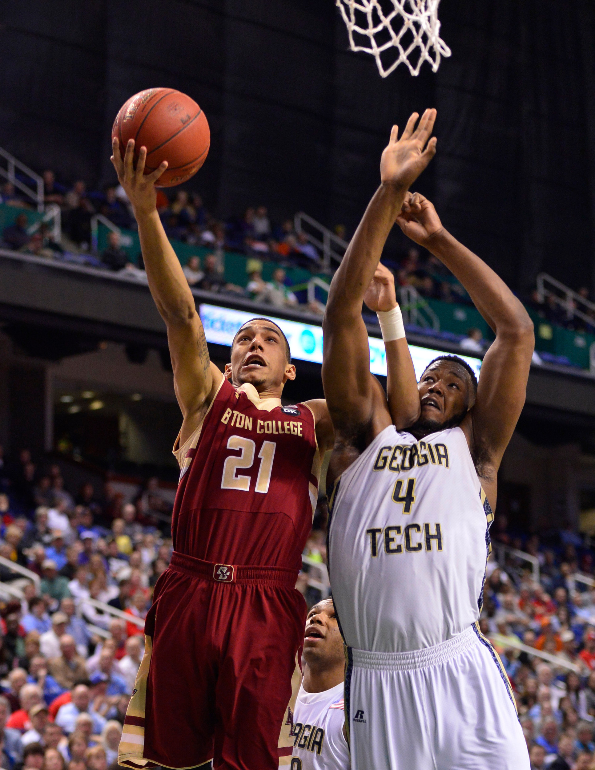 Mar 12, 2014; Greensboro, NC, USA; Boston College Eagles guard Olivier Hanlan (21) shoots as Georgia Tech Yellow Jackets forward Robert Carter, Jr. (4) defends in the first half in the first round at Greensboro Coliseum. Mandatory Credit: Bob Donnan-USA TODAY Sports