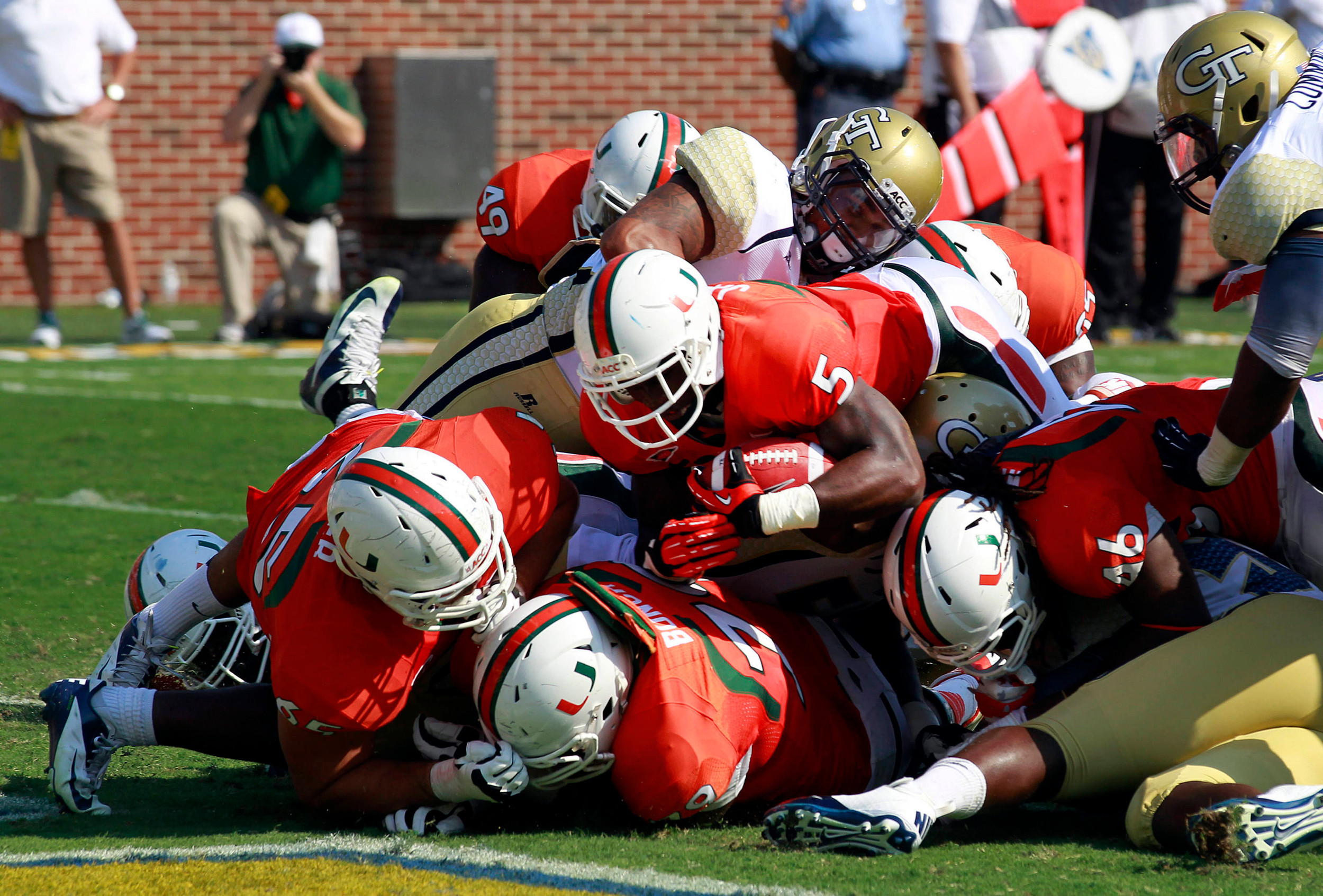 Miami running back Mike James (5) dives in for a touchdown in the first half of an NCAA college football game against Georgia Tech in Atlanta on Saturday, Sept. 22, 2012. (AP Photo/John Bazemore)