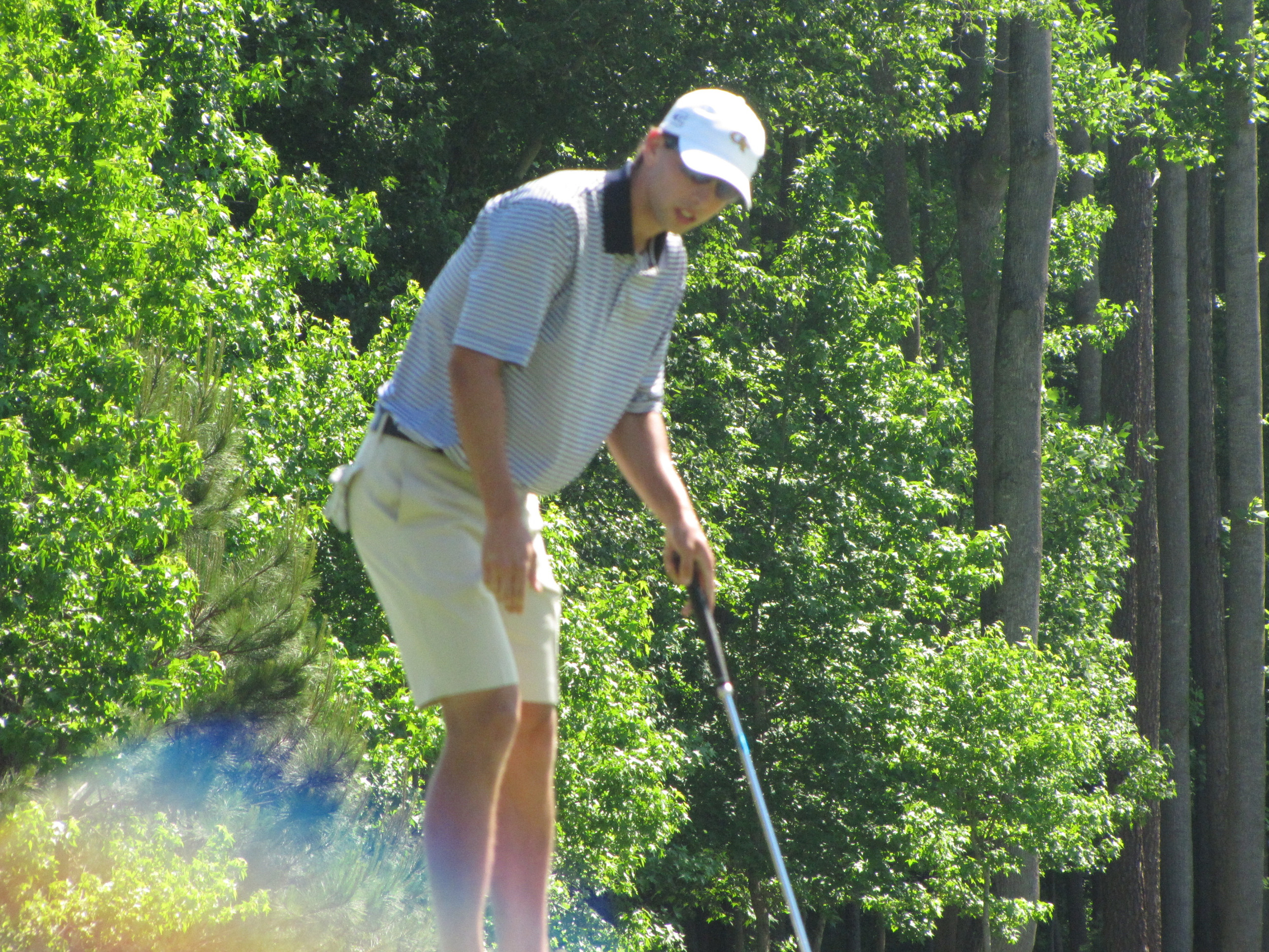 Seth Reeves watches his birdie putt at 5 slide by the hole during the final round of the NCAA Raleigh Regional.